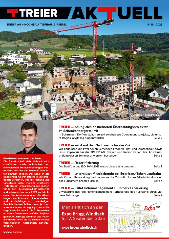 Titelbild Treier Aktuell 19_25 Construction site with two red cranes towering over partially built multi-story buildings in a green rural area; magazine masthead TREIER AKTUELL at the top left.